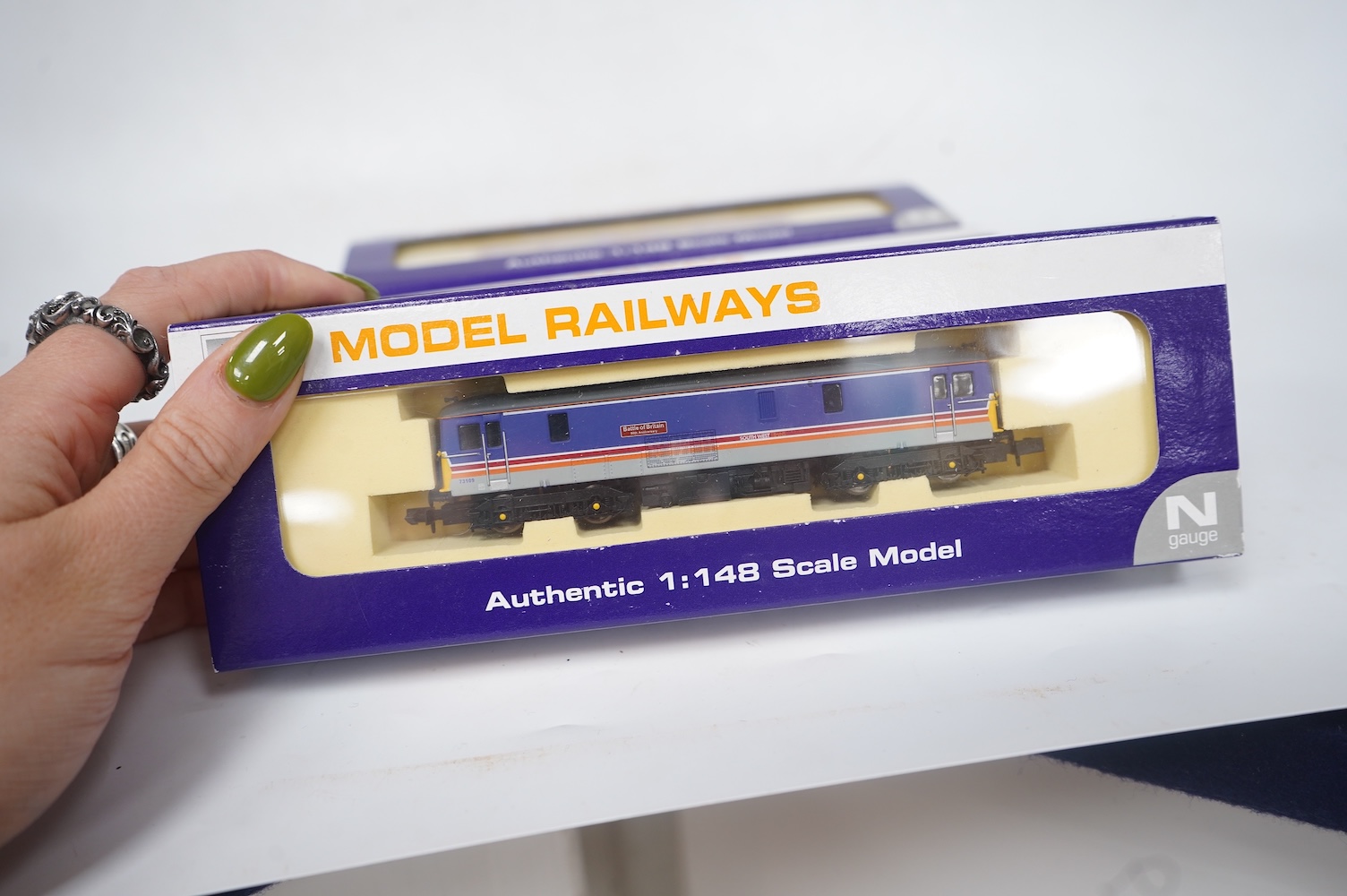 Three boxed Dapol N gauge railway Class 73 electro-diesel locomotives; 73109 Battle of Britain (ND006), 73114 Stewarts Lane (ND-021a) and 73128 (ND005). Condition - good.